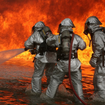 Aircraft Rescue Firefighting Marines begin to combat fires during a simulated fire exercise