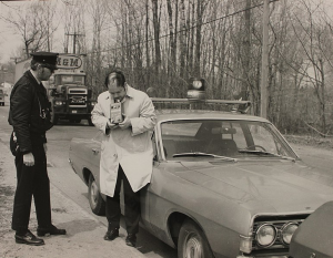 picture shows a police officer administering a breathlyzer to a driver