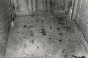 black and white picture showing bloodstains on the floor of a room